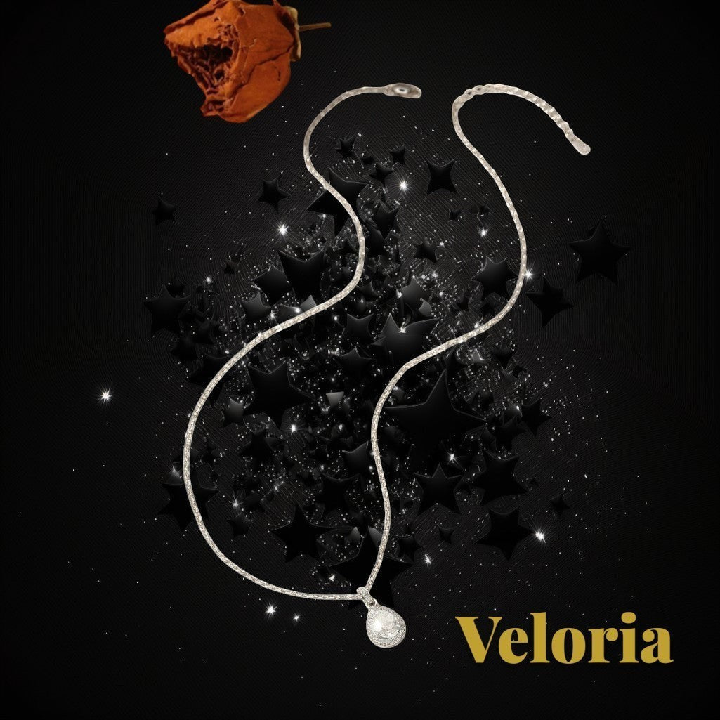 Gr8est Veloria 1.2CT water drop moissanite pendant necklace in 925 sterling silver on a black star-themed background.