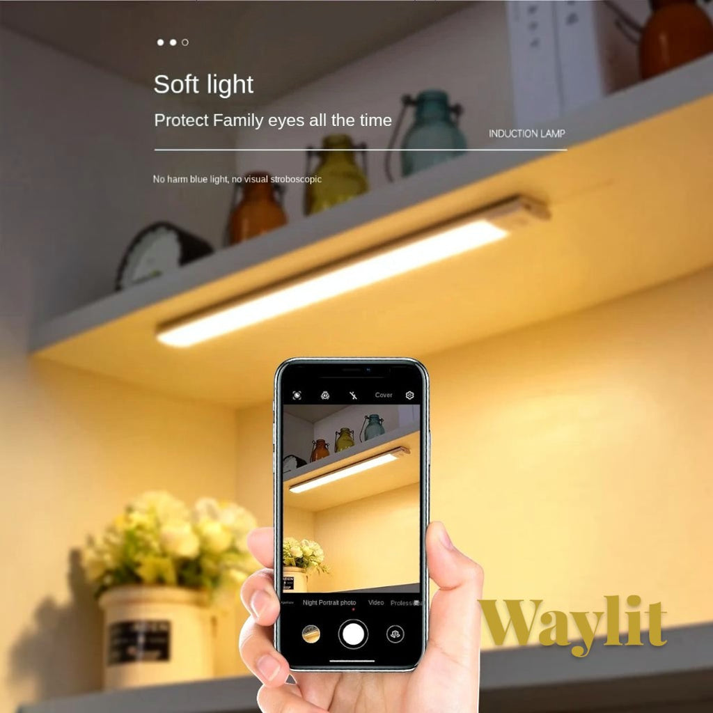 Gr8est Waylit motion sensor LED bar light mounted under a shelf, emitting a warm glow for cabinet illumination.