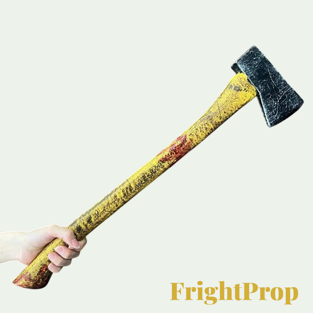 Gr8est foam axe prop with a weathered yellow handle and dark blade, held by a hand for a realistic Halloween costume.