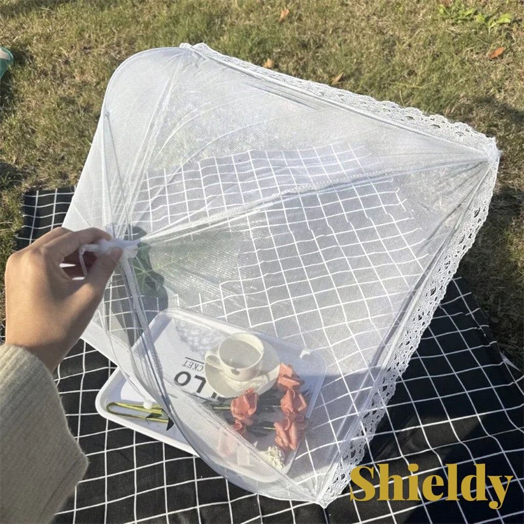 Gr8est white pop-up mesh food cover with lace trim protecting a picnic tray on a black and white checkered blanket